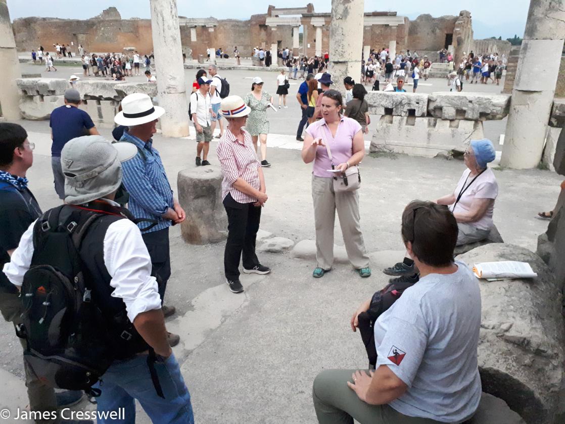 A photograph of archaeologist Abby Cresswell explaing the archaeology of Pompeii on GeoWorld Travel's geology of Italy tour