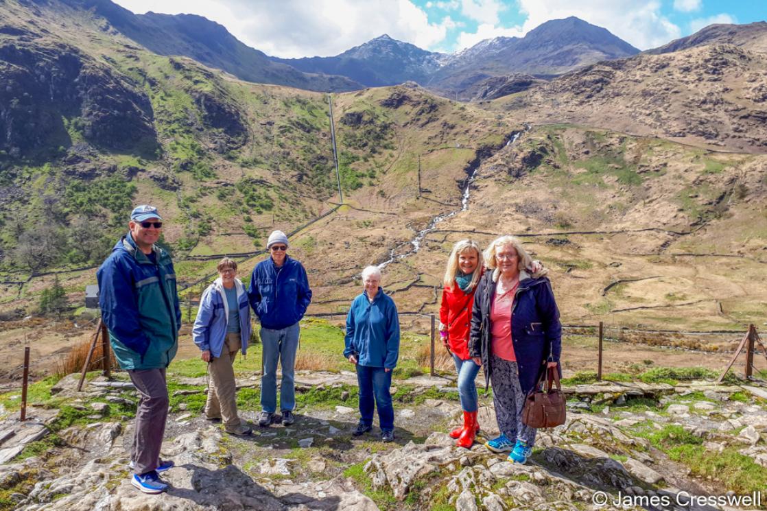 A photograph of a group of people standing infront of Snowdon, on a GeoWorld Travel Wales geology trip, tour and holiday
