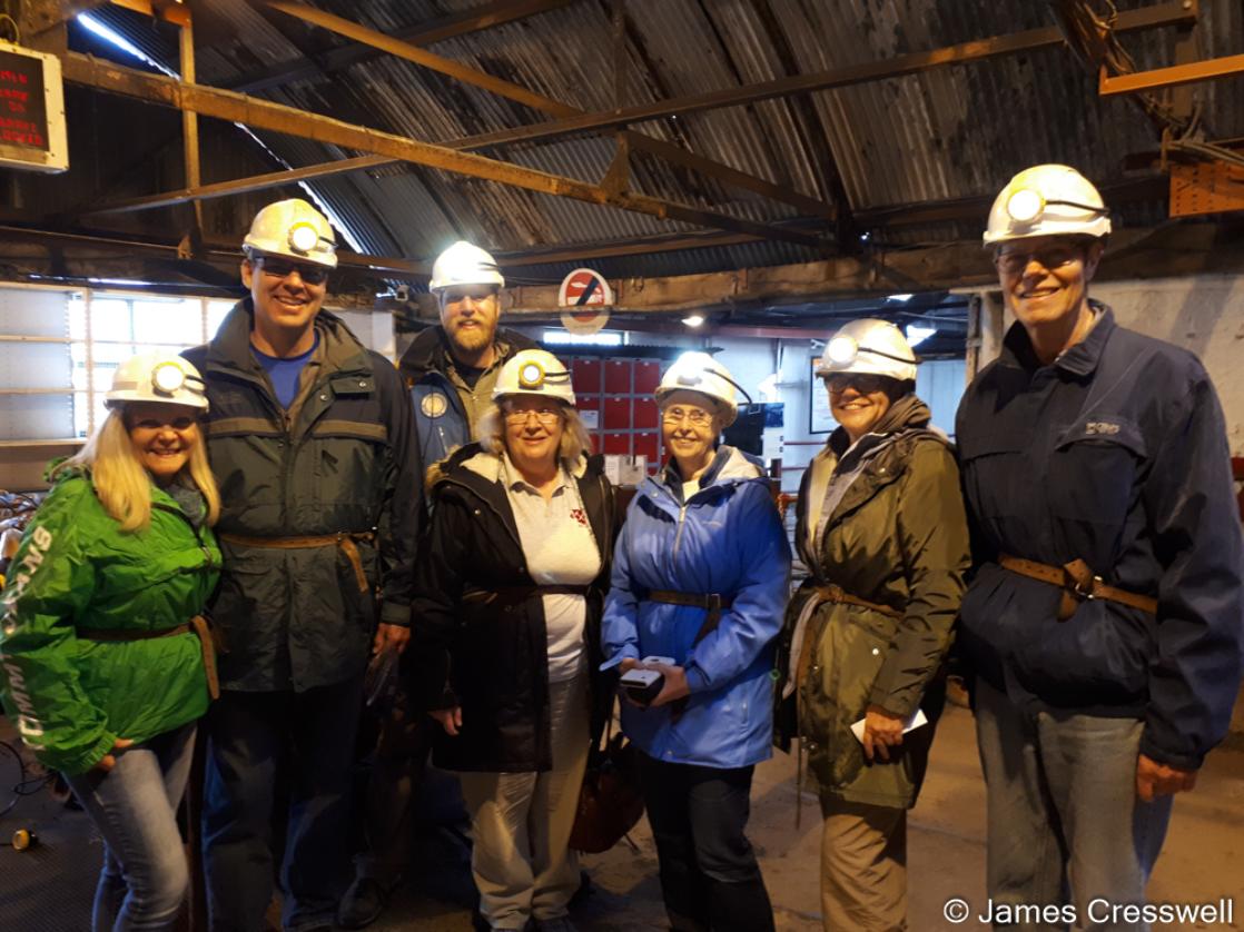 A photograph of a group of people wearing hardhats who are just about to descend the Big Pit, taken on the GeoWorld Travel England and Wales geology trip, tour and holiday