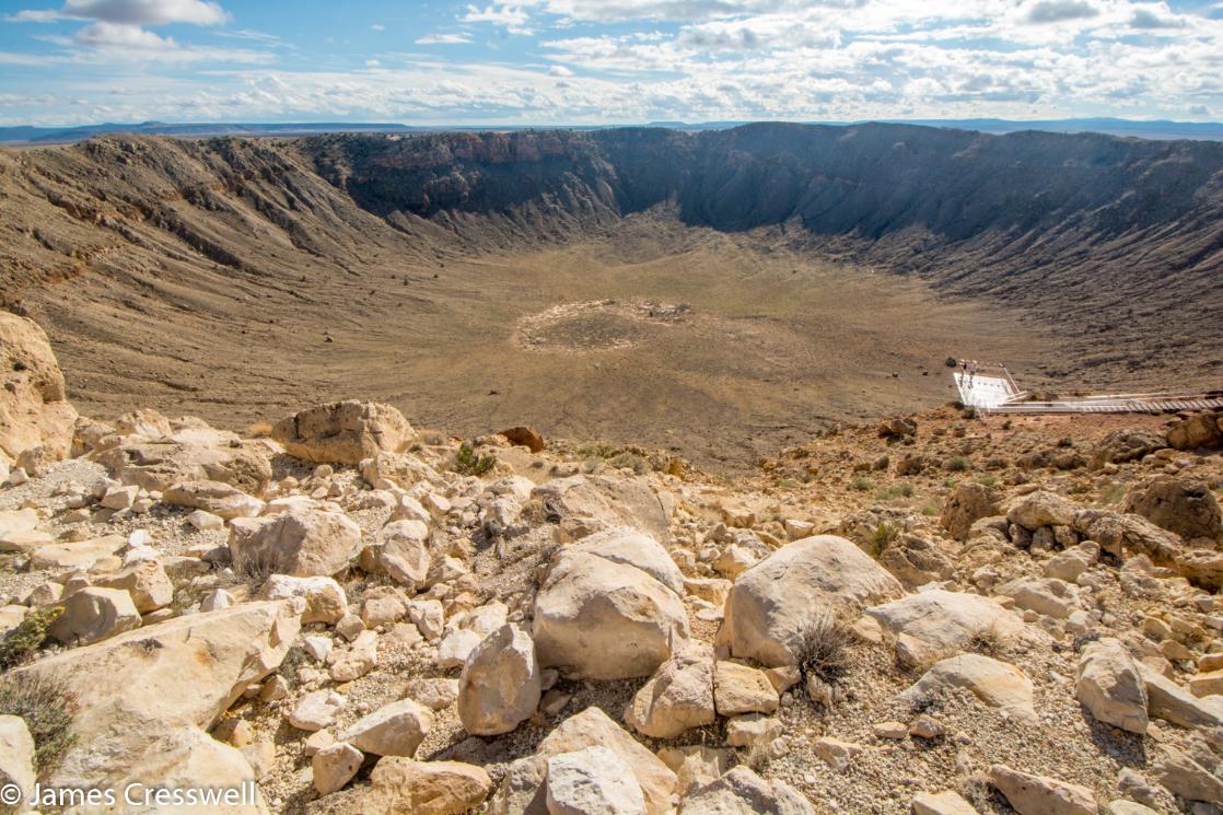 A photograph of a huge crater, a meteor impact crater, Meteor Crater in Arizona, taken on a GeoWorld Travel USA geology trip and holiday