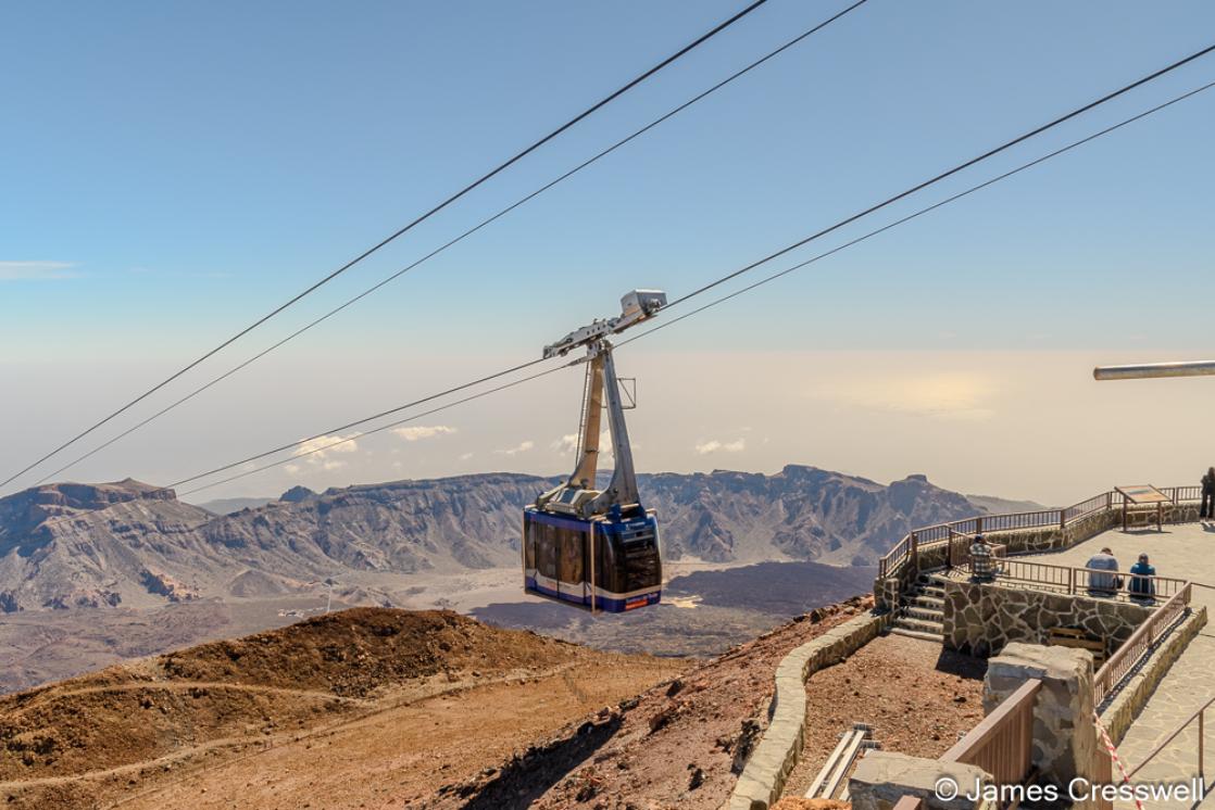 A photograph of a cable car arriving at the upper cable car station, just 200m beneath the summit of Teide