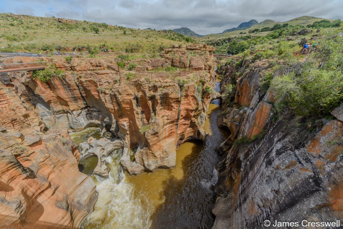  A photograph of  Bourke’s Luck Potholes, over millions of years, swirling water has scoured out deep cylindrical cavities in the hard bedrock. The place is named after Thomas Bourke whomade a lucky gold strike here in the 1880s. 